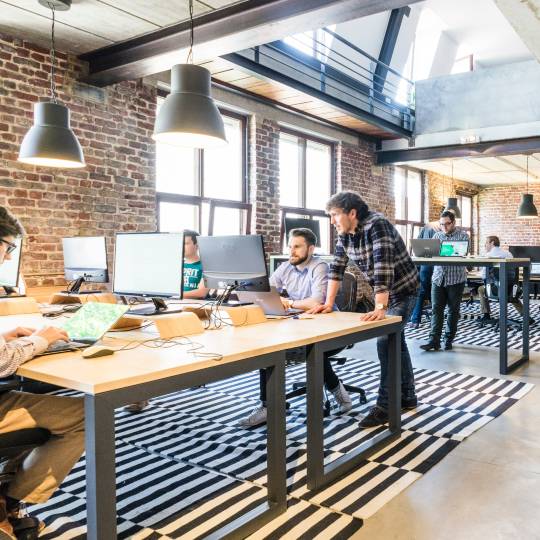 Employees in office discussing managed microsoft sentinel service