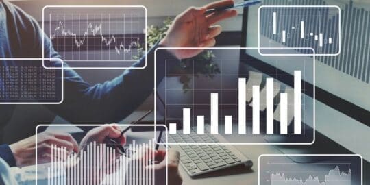 How Often Should You Conduct Penetration Testing? 3 Two people looking at data on computer screen with graphic overlay
