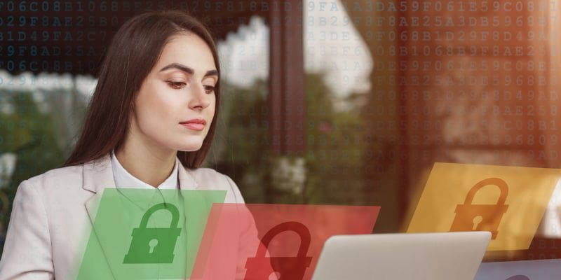 woman looking at laptop screen with graphic padlock overlays